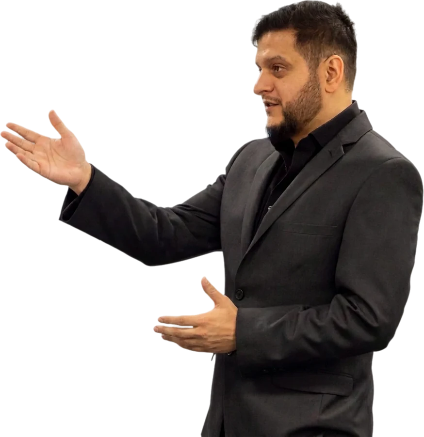 Faisal Mahmood speaking, in a charcoal jacket and black shirt